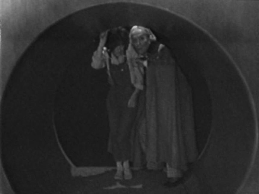 The Doctor and Susan hide in the overflow pipe