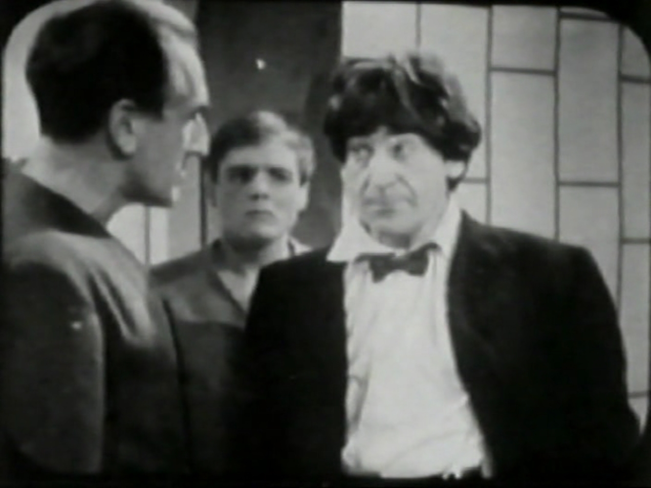 The Doctor confronts Bragen as Ben looks on.