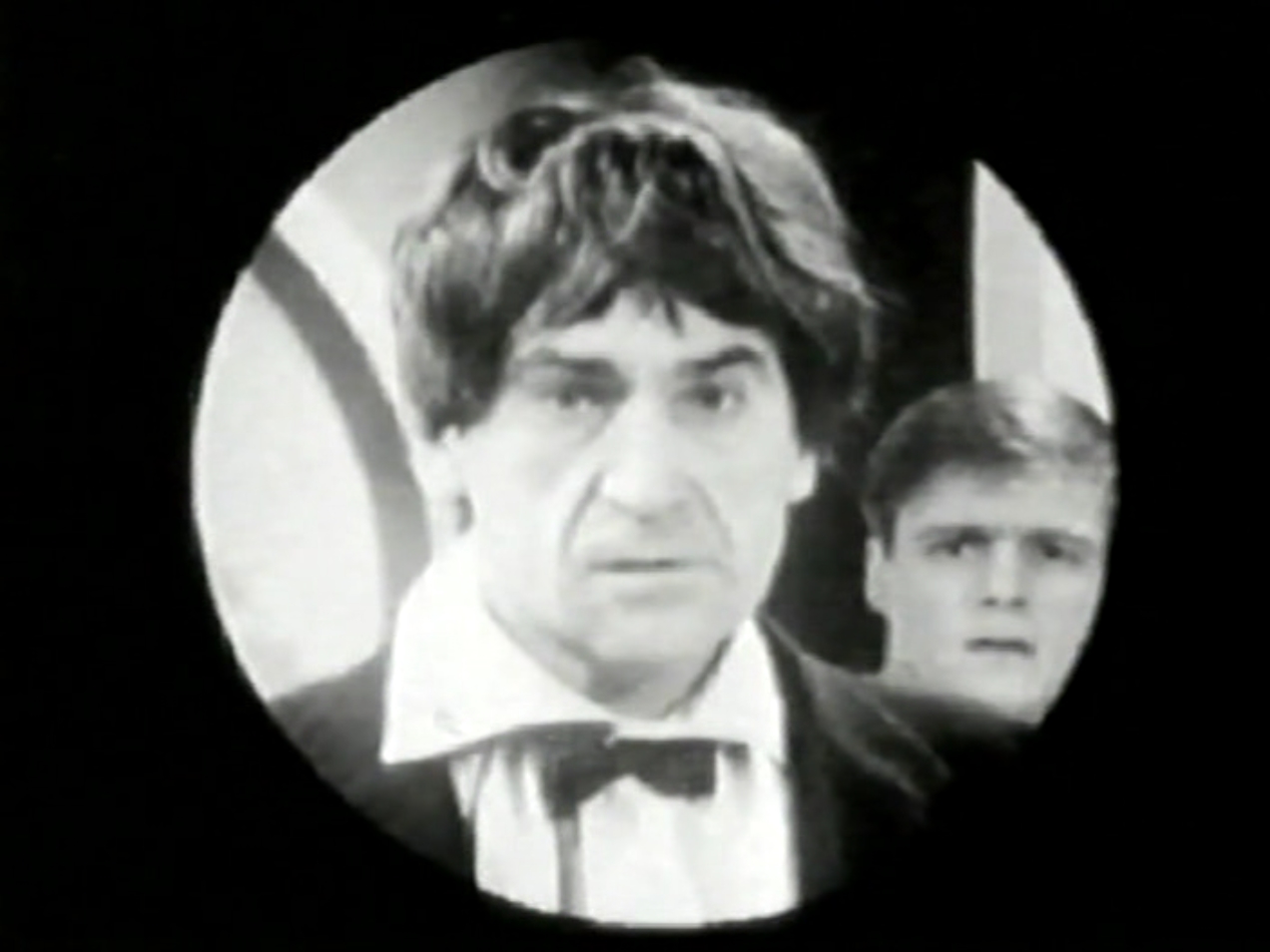 A view of the Doctor through the Dalek's eyestalk. Ben is also visible.