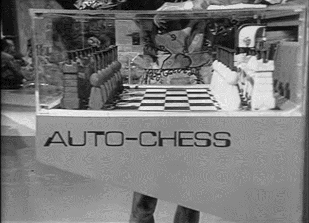 Chessboard in a glassbox with a machine labelled "auto-chess"