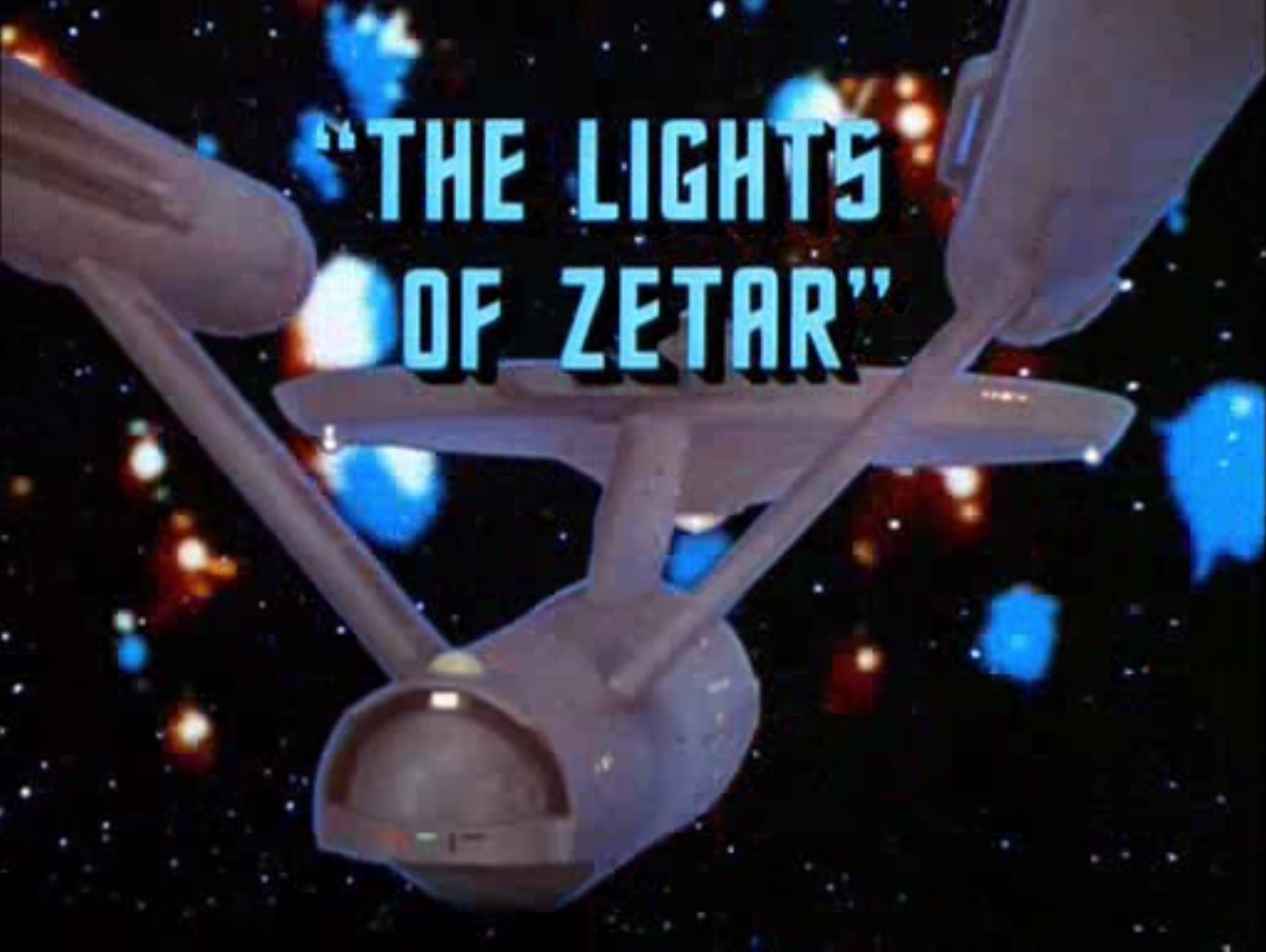 title card for the episode projected over a rear view of the Enterprise in front of a cloud of shimmering lights of Zetar