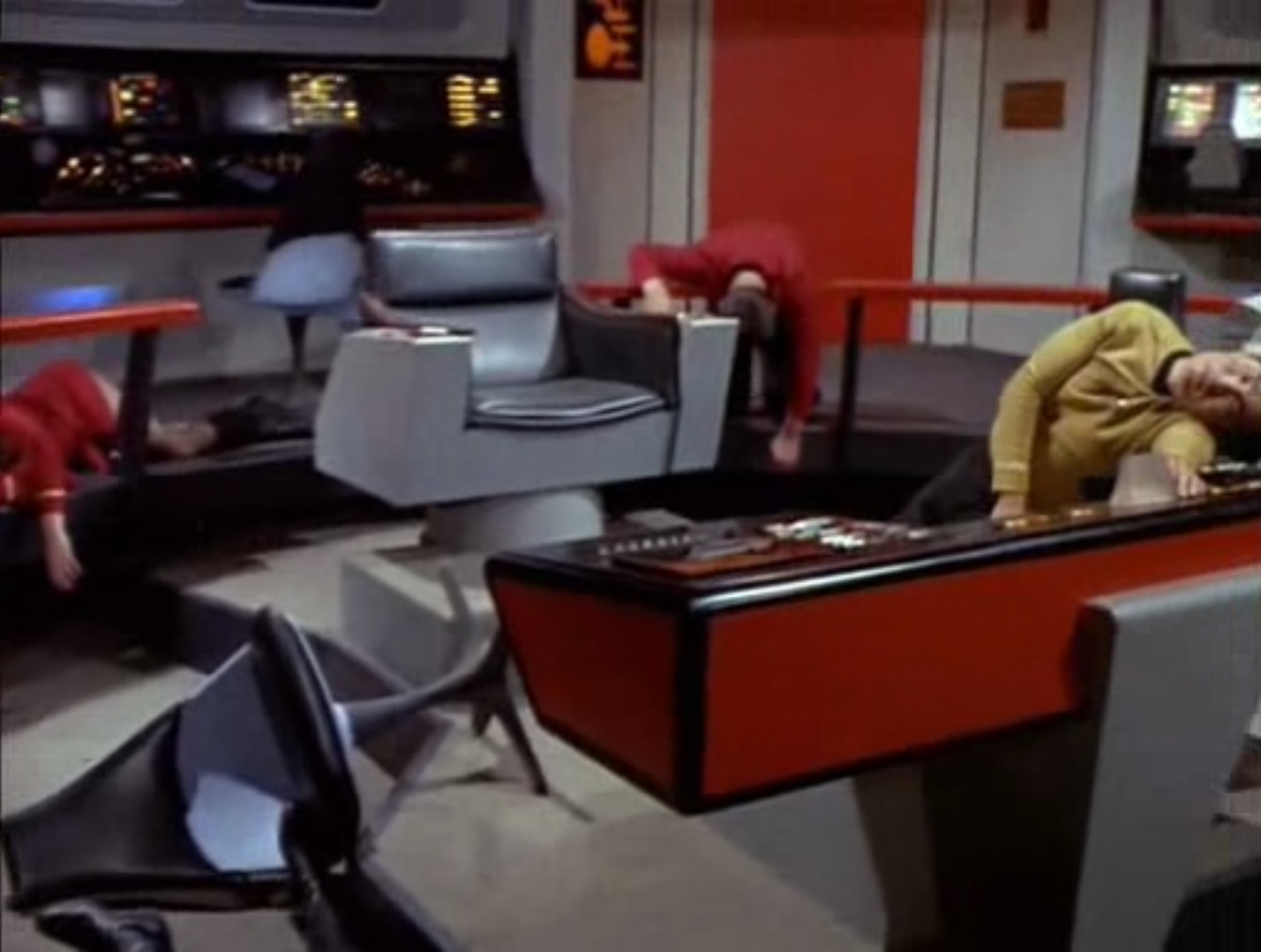 screen shot of the Enterprise bridge, Sulu, Lieutenant Palmer, and someone else all unconscious at their stations