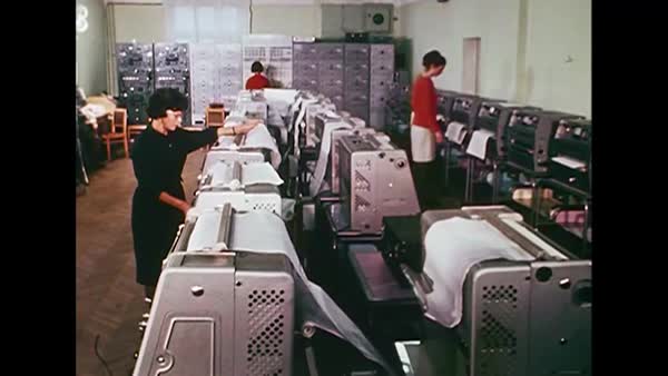 three women operate a room full of line printers somewhere in the Soviet Union