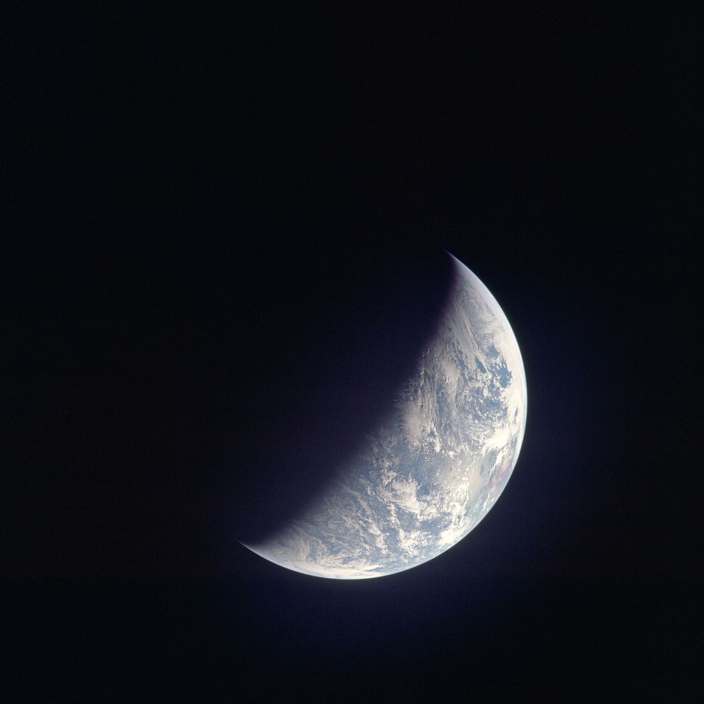 A photograph of a crescent Earth taken by Apollo 12 crew on their way to the moon.