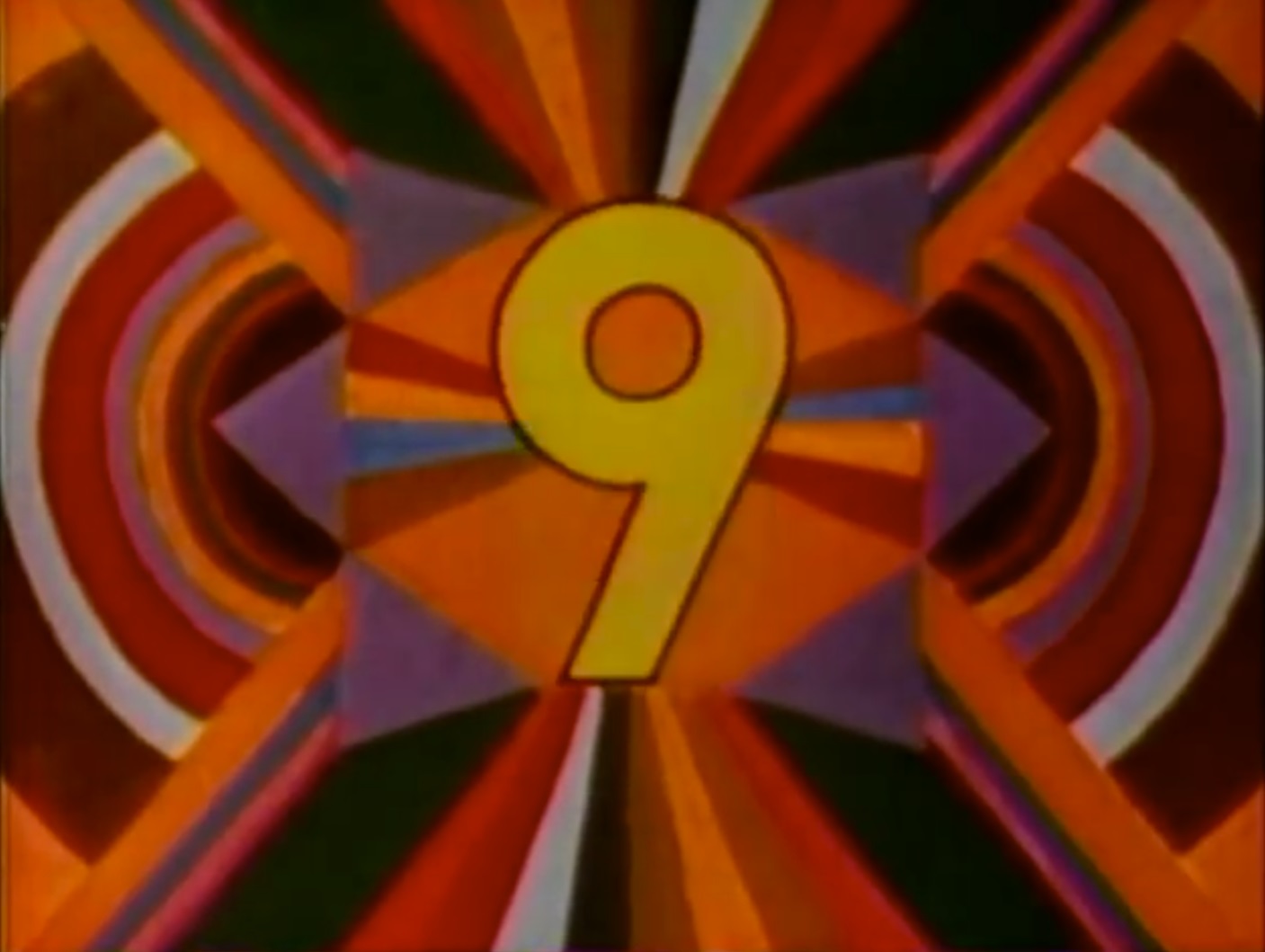 still illustration of bands of colors radiating out in a kaleidoscopically mirrored fashion, from the number nine