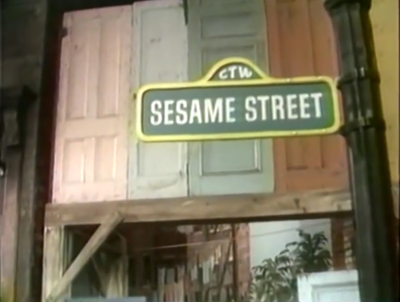 still photo of a sign reading 'Sesame Street'