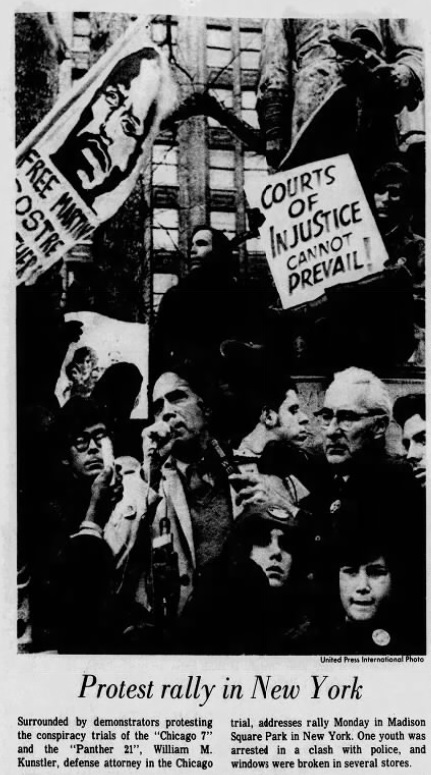 A news clipping, showing a crowd of people in front of a statue. Two people carry signs. One says 'COURTS OF INJUSTICE CANNOT PREVAIL!'. The other says 'FREE MARTIN SOSTRE'. The caption of the news clipping reads 'Protest rally in New York: Surrounded by demonstrators protesting the conspiracy trials of the Chicago 7 and the Panther 21, William M. Kunstler, defense attorney in the Chicago trial, addresses rally Monday in Madison Square Park in New York. One youth was injured in a clash with police, and windows were broken in several stores.'