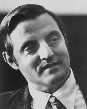 A black and white photo of Walter Mondale, a white man with dark hair wearing a suit and tie.  He is looking to the right of the viewer with a neutral expression.