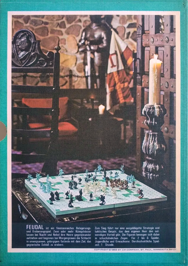 Colour box-art photograph of a game in progress in a 'medieval' themed room