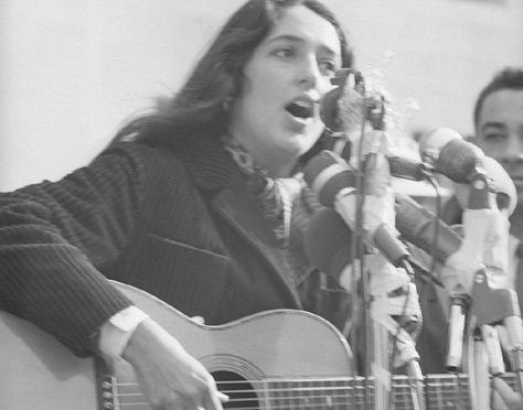 Joan Baez playing guitar