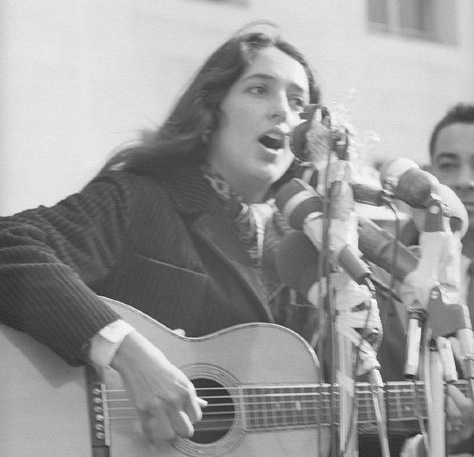 Joan Baez playing guitar