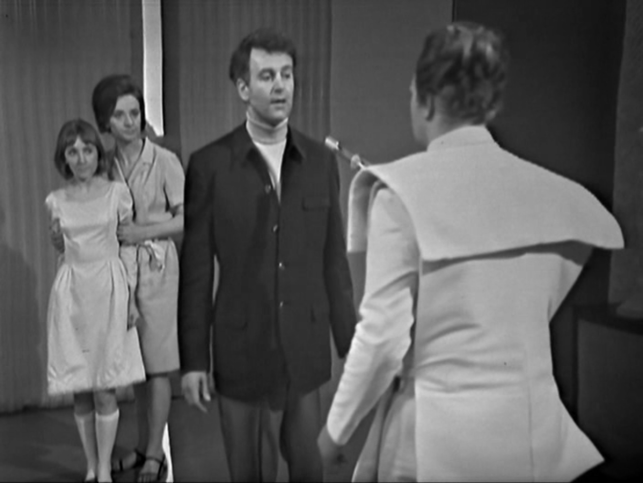 Ian stares down the barrel of a gun, with Barbara and Vicki behind him.