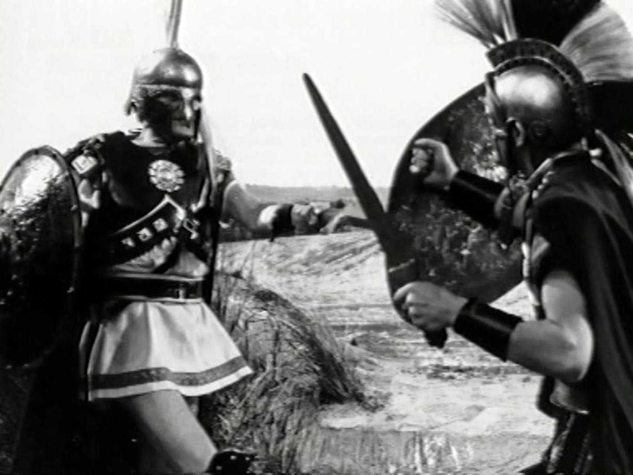 Desc: A man in Greek armour fights a man in Trojan armour.