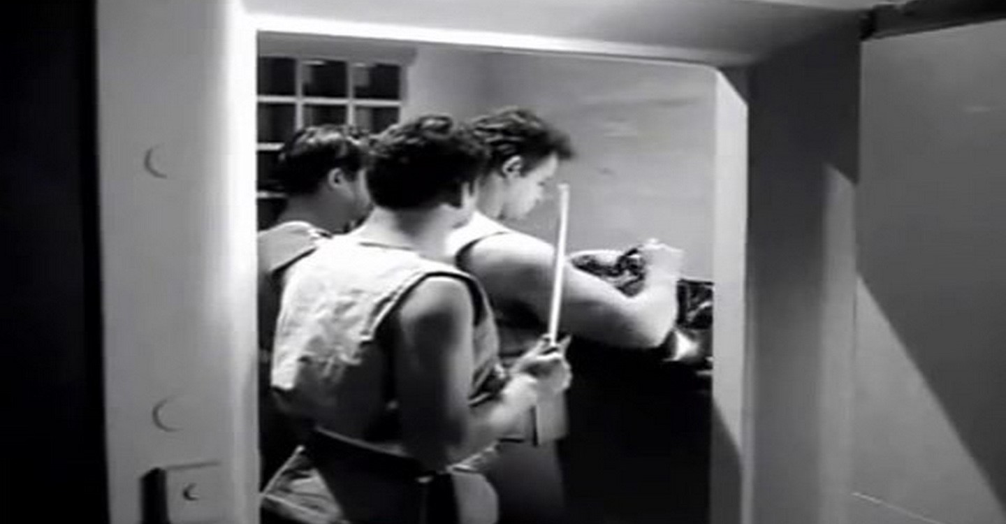 Three men dressed in grecco style clothing while emptying out the safe deposit boxes.