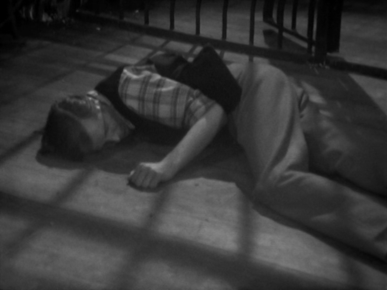 Image: Warren Earp lying face down on the floor.