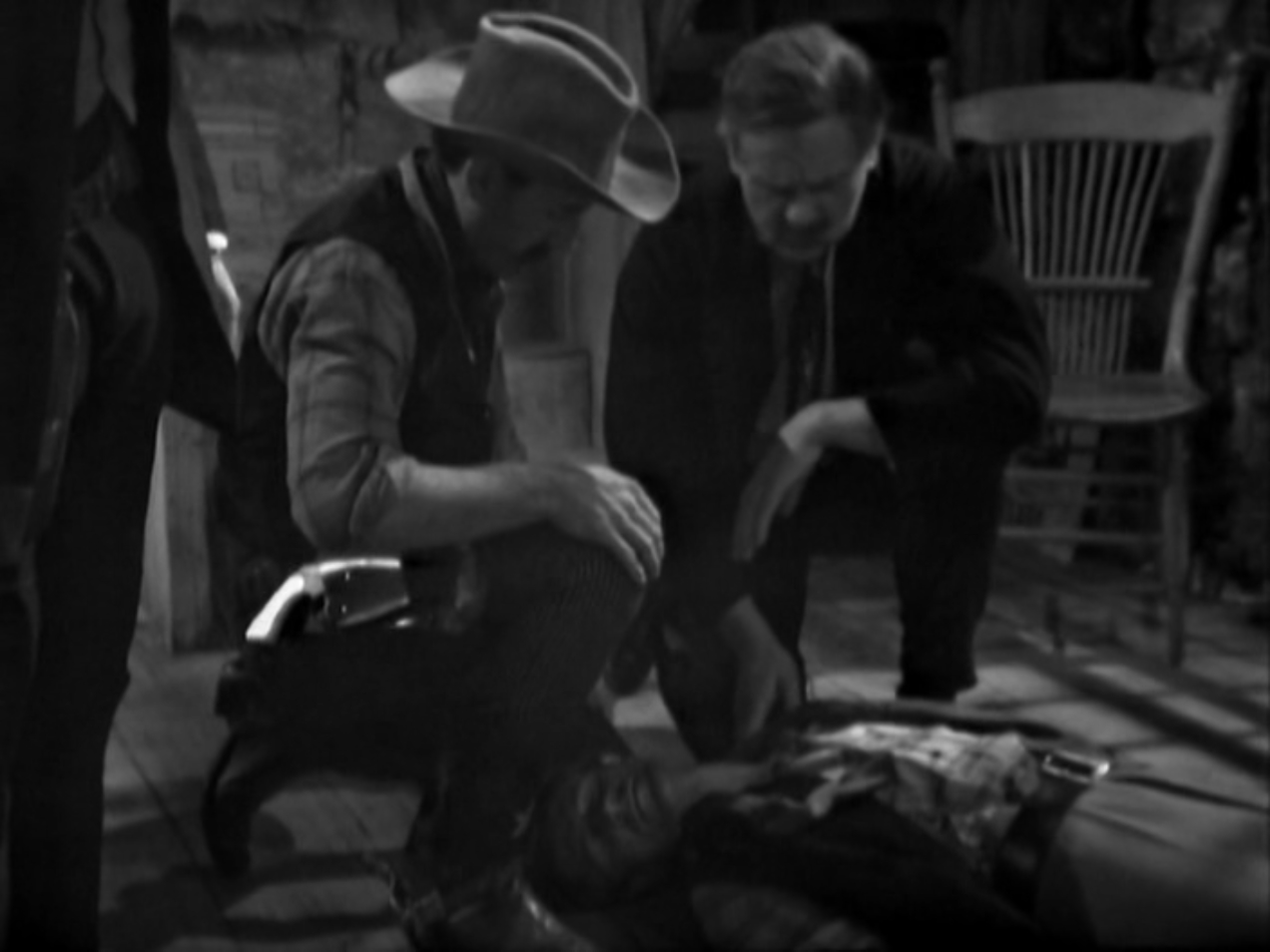 Image: The Earps kneel over their dead brother. 