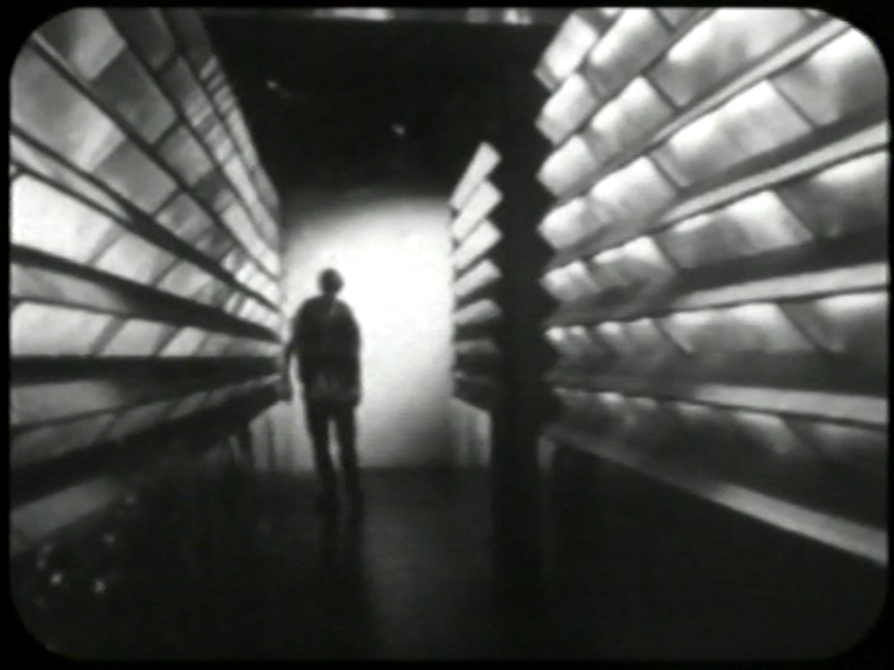 A lone man at the end of a hallway.