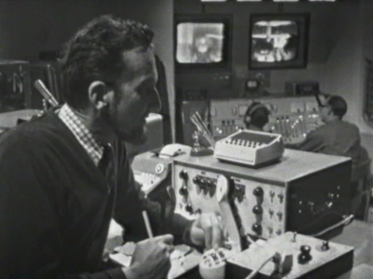 Image: Barclay (foreground) sits in the control room