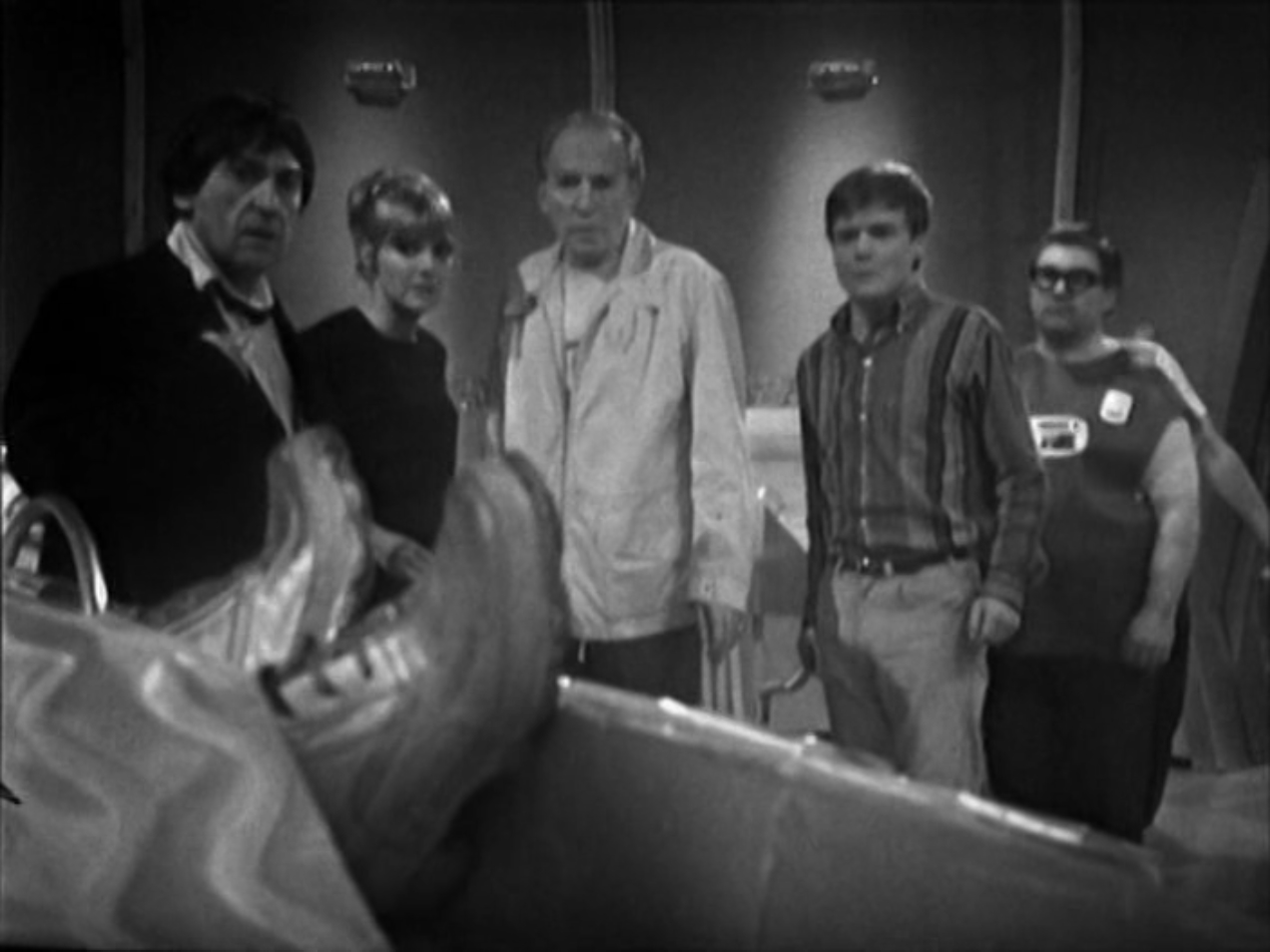 the doctor and company look on in horror as they spot a pair of silver shoes underneath the covers of a hospital bed