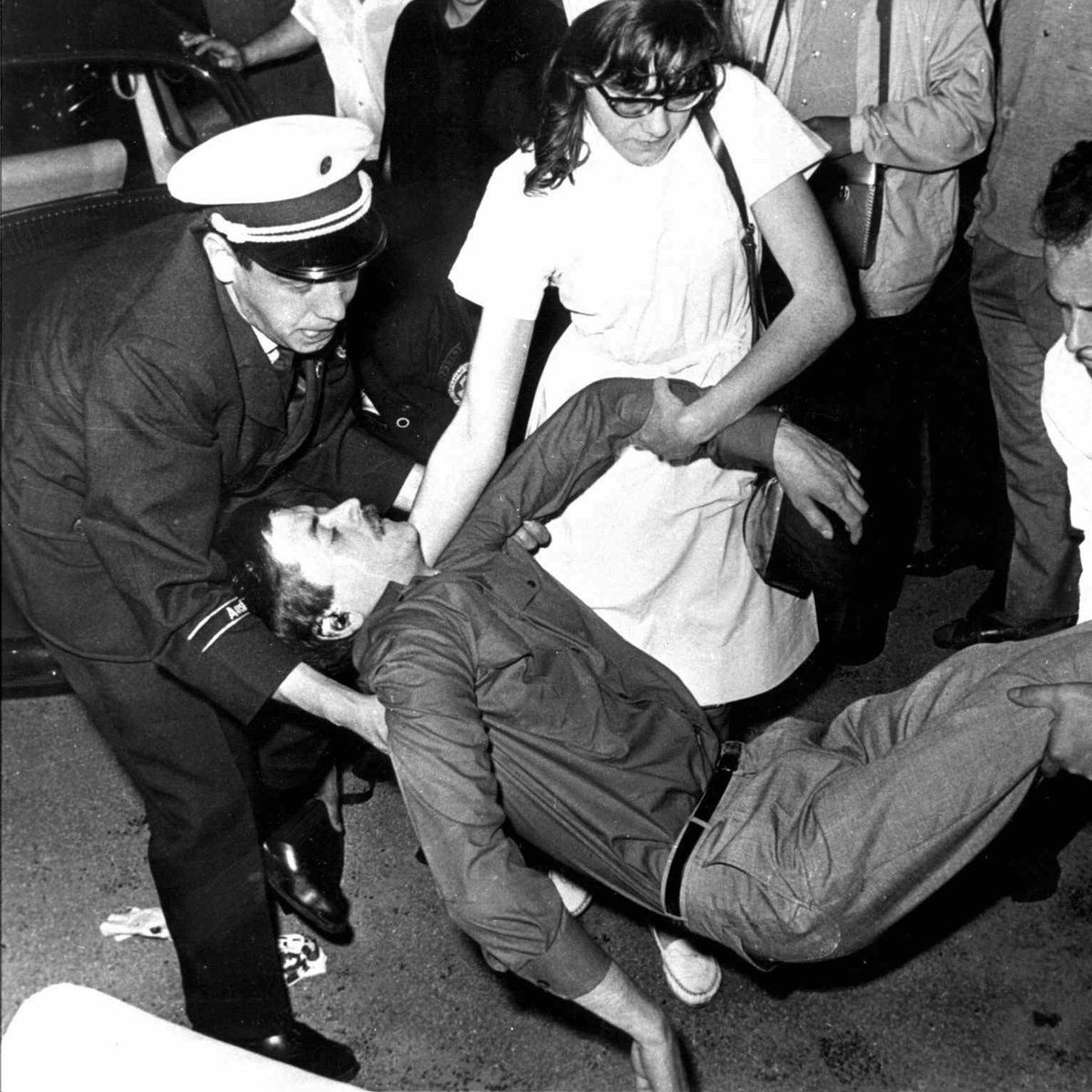 Police officer and nurse load Benno Ohnesorg into an ambulance