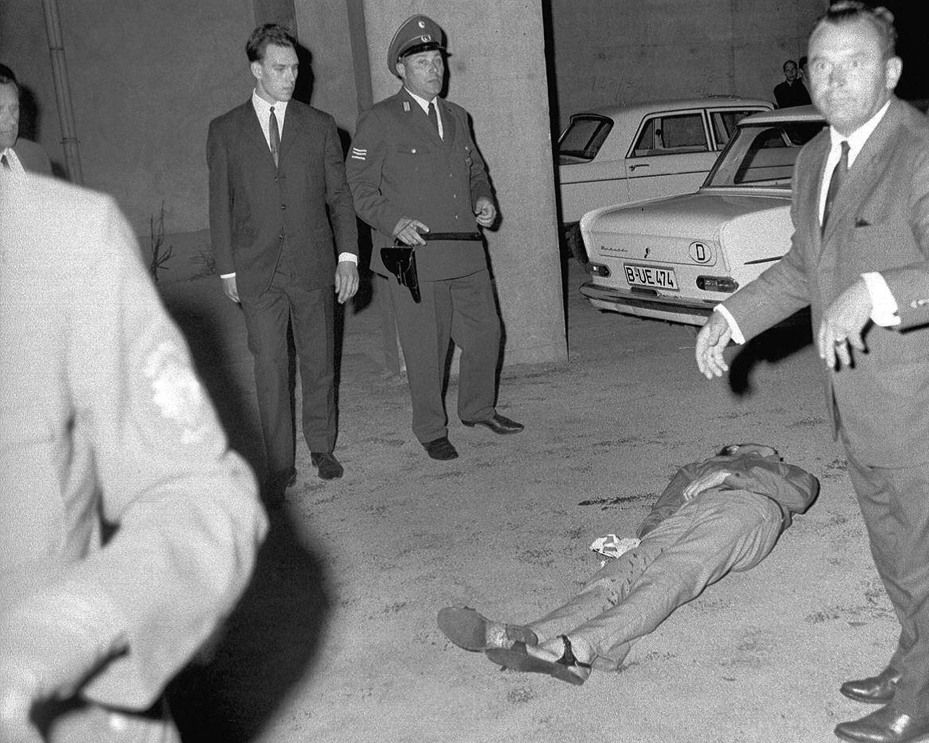 Police officers stand around Benno Ohnesorg