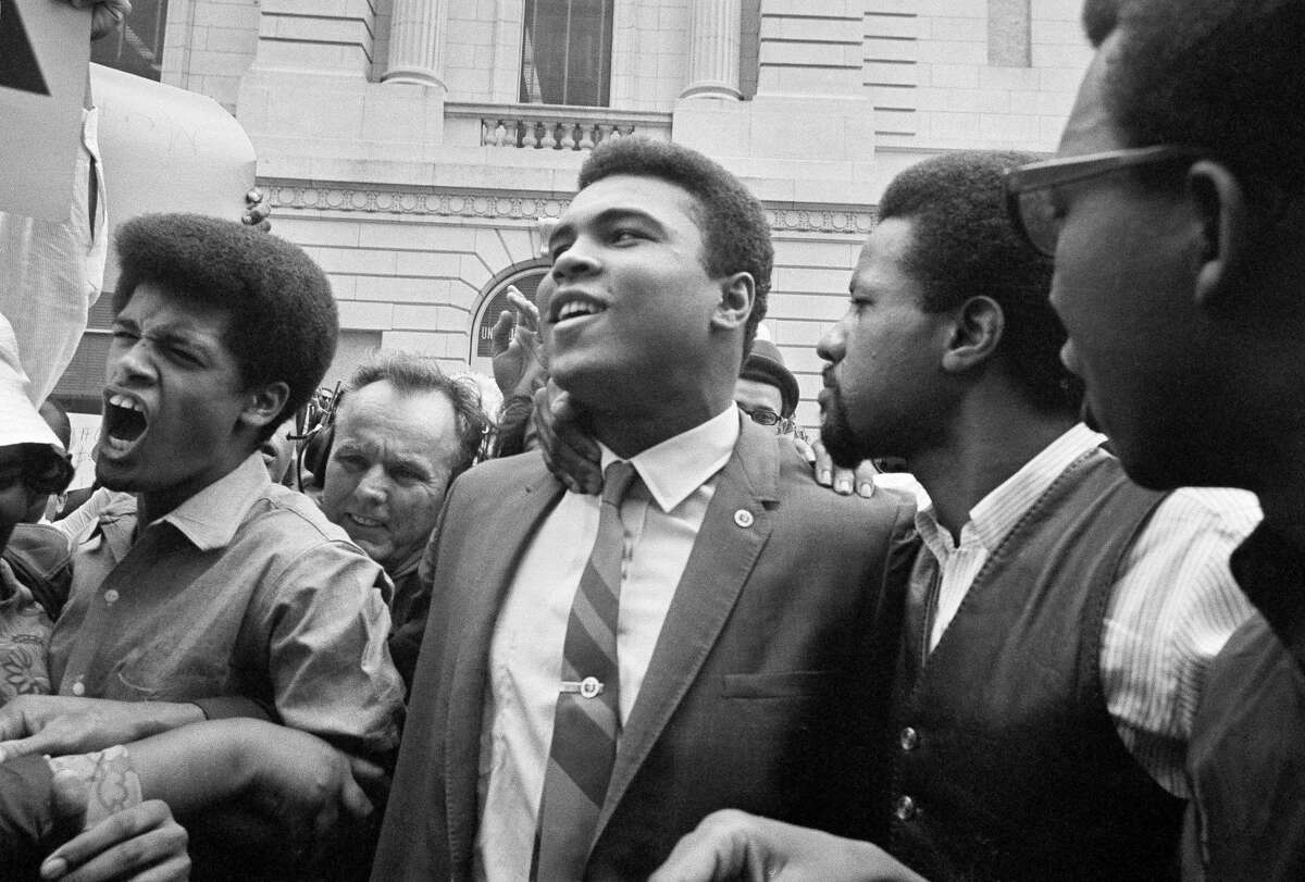 Muhammad Ali and friends at the Houston courthouse after he refuses to be drafted