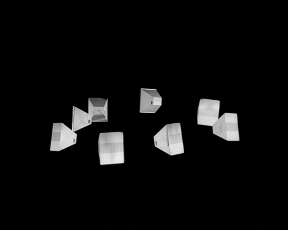 ID: Monochrome photo, the segments of the space beacon, against a black void. The segments are wedge-shaped, and there are 8 of them.