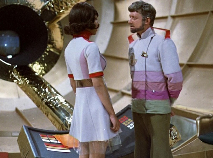 An image from Beach Head where Cassandra Jackson (Helen Dowling) talks to Commander Tom Decker (Ed Bishop) on the spaceship.