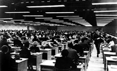 Photo of a large open office with almost endless rows of identical desks