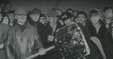 A group of ordinary people standing with homemade weapons ready to police their community