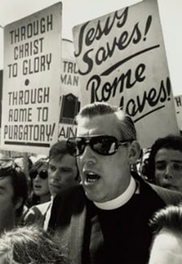 Iain Paisley leading a protest rally against Catholicism including signs that say things like: "Through Christ to Glory Through Rome to Purgatory"