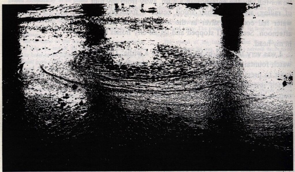 PHOTO: An black and white photo of ripples in water, possibly a lake. 