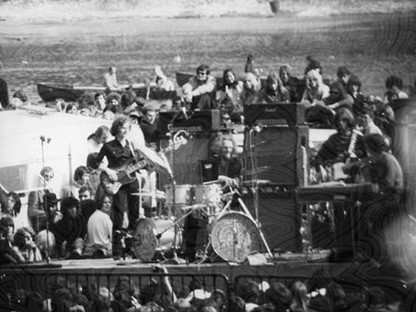 Black and white photo of Blind Faith performing live in Hyde Park in summer 1969.