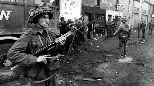 British Troops in Ulster in front of a burnt out shop