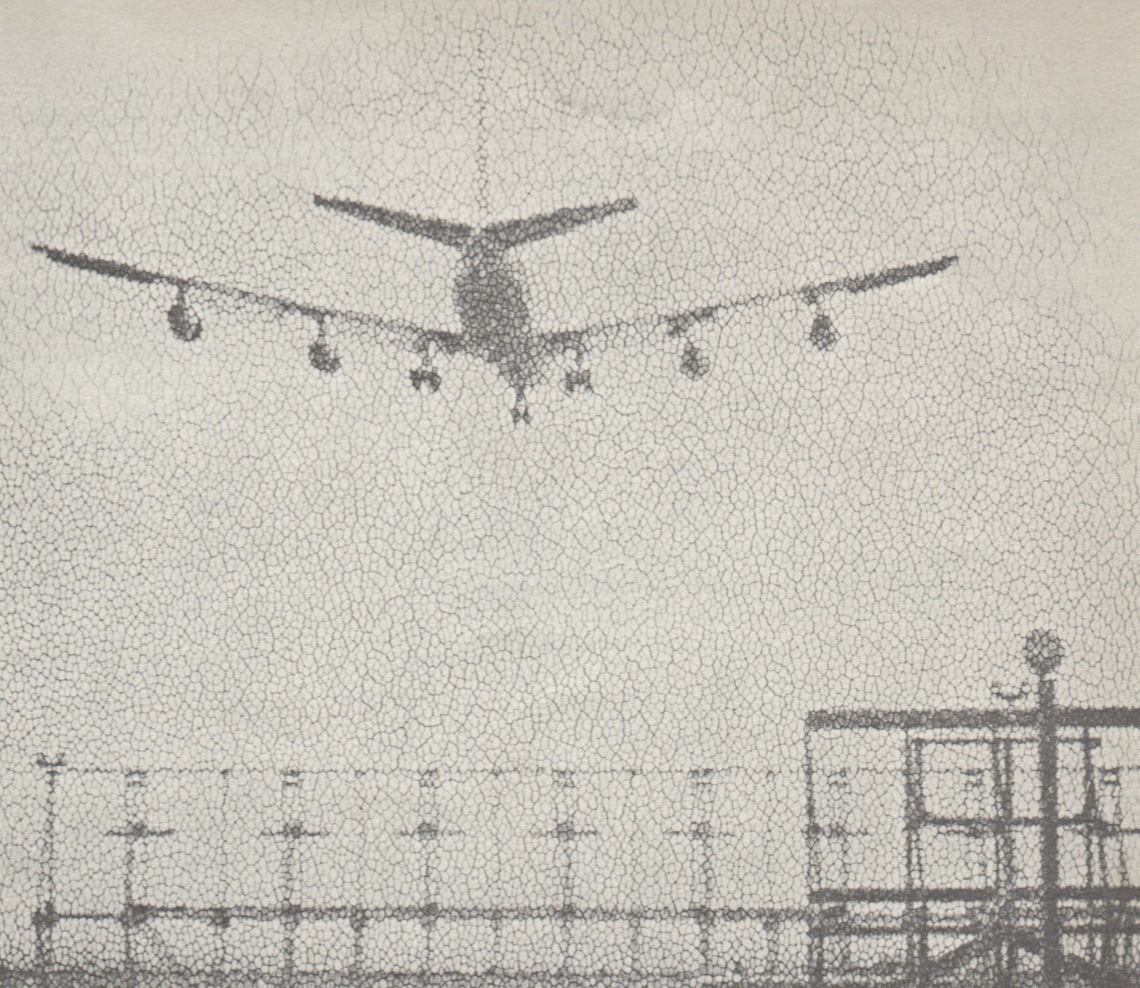 Grainy black-and-white photograph of an airplane seen from behind. The lower third of the photograph has a metallic fence.