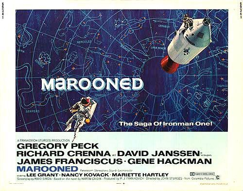 Movie poster. The illustration has a space module and an astronaut on a blue background with some Zodiac constellations represented. The text includes the movie title "Marooned" in all caps, the tagline "The Saga of Ironman One!", as well as the main cast of the movie listed below the image: Gregory Peck, Richard Crenna, David Janssen, James Franciscus, Gene Hackman, co-starring Lee Grant, Nancy Novack, Mariette Hartley.