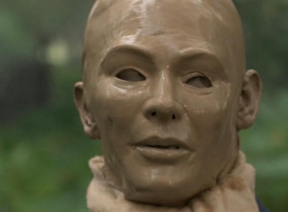 An Auton with blank eyes looking at the camera.