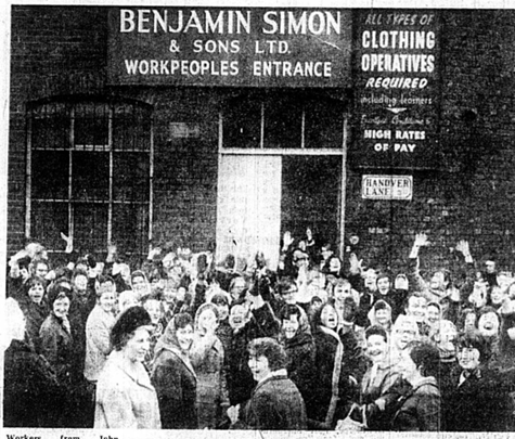 A group of women standing outside Benjamin Simon, cheering at the camera