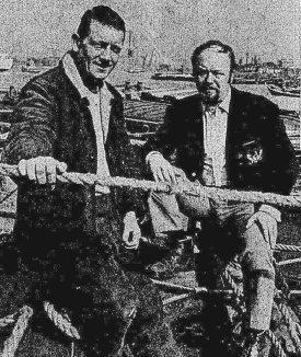 Black and White photo of Joint Prime Ministers of the short lived republic, Ray Padgett and John Westfallen standing in front of the docklands but behind a rope.