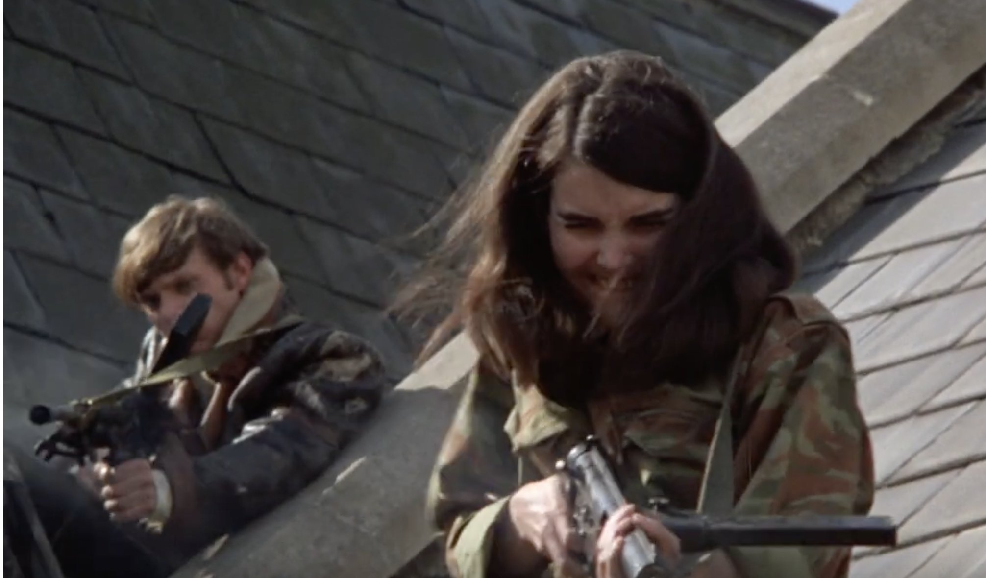 Christine Noonan as The Girl firing a machine gun