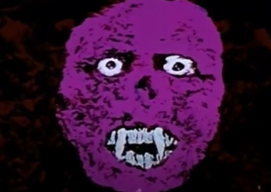 A crude, 2D portrait of the monster's face. The face is flat bright purple, with pointy white teeth and rolling eyes. Negative space is filled in with black.