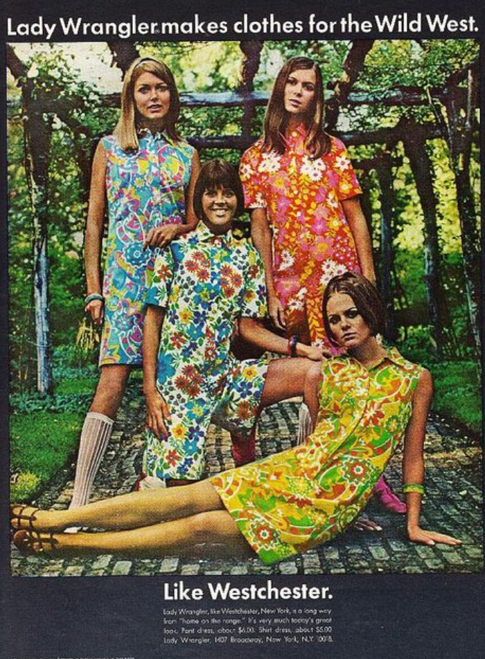 Colour advertisement proclaiming that 'Lady Wrangler makes clothes for the Wild West - Like Westchester', with a quartet of well coifed white women smiling at the camera, dressed in bright, even psychedelic, floral-printed summer outfits