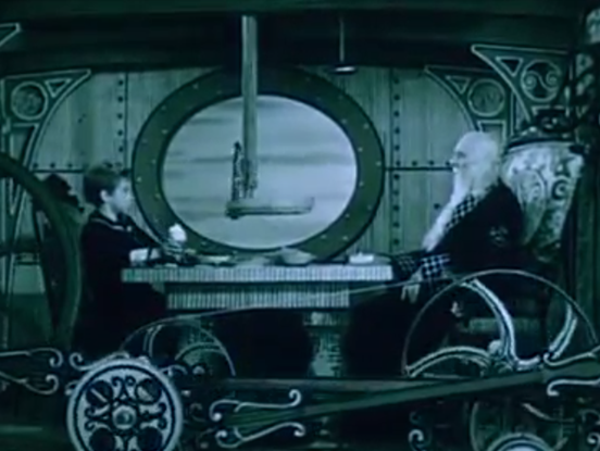 Child and Nemo in a cog filled submarine cabin eating lunch together.